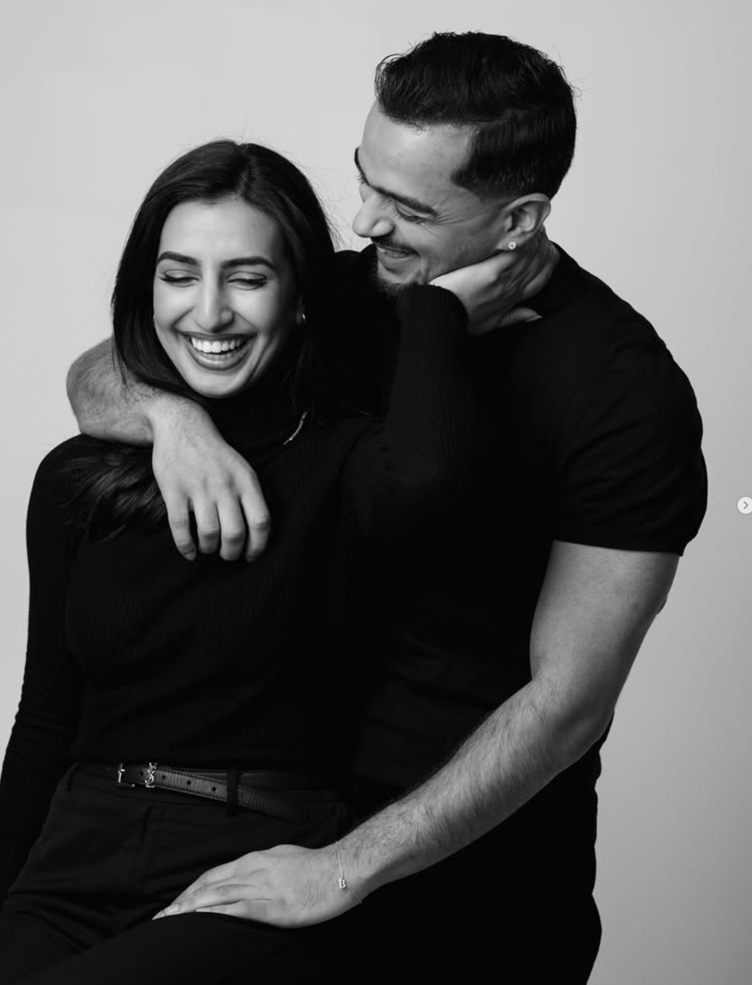 Joyful studio couple portrait photographed by Pamila