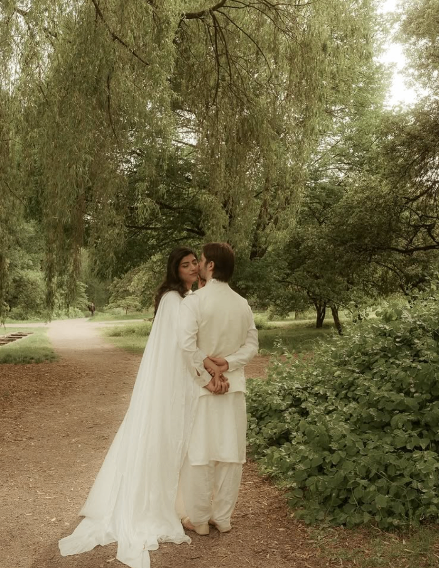 Couple portrait in a green park photographed by Pamila